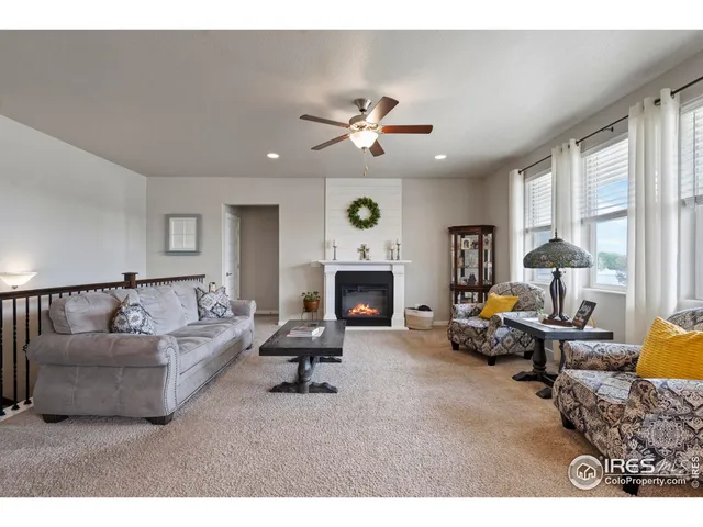a living room with furniture fireplace and window