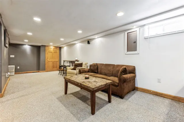 a living room with furniture and a large window with projector