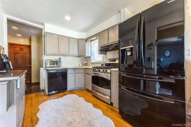 a kitchen with granite countertop stainless steel appliances and wooden cabinets