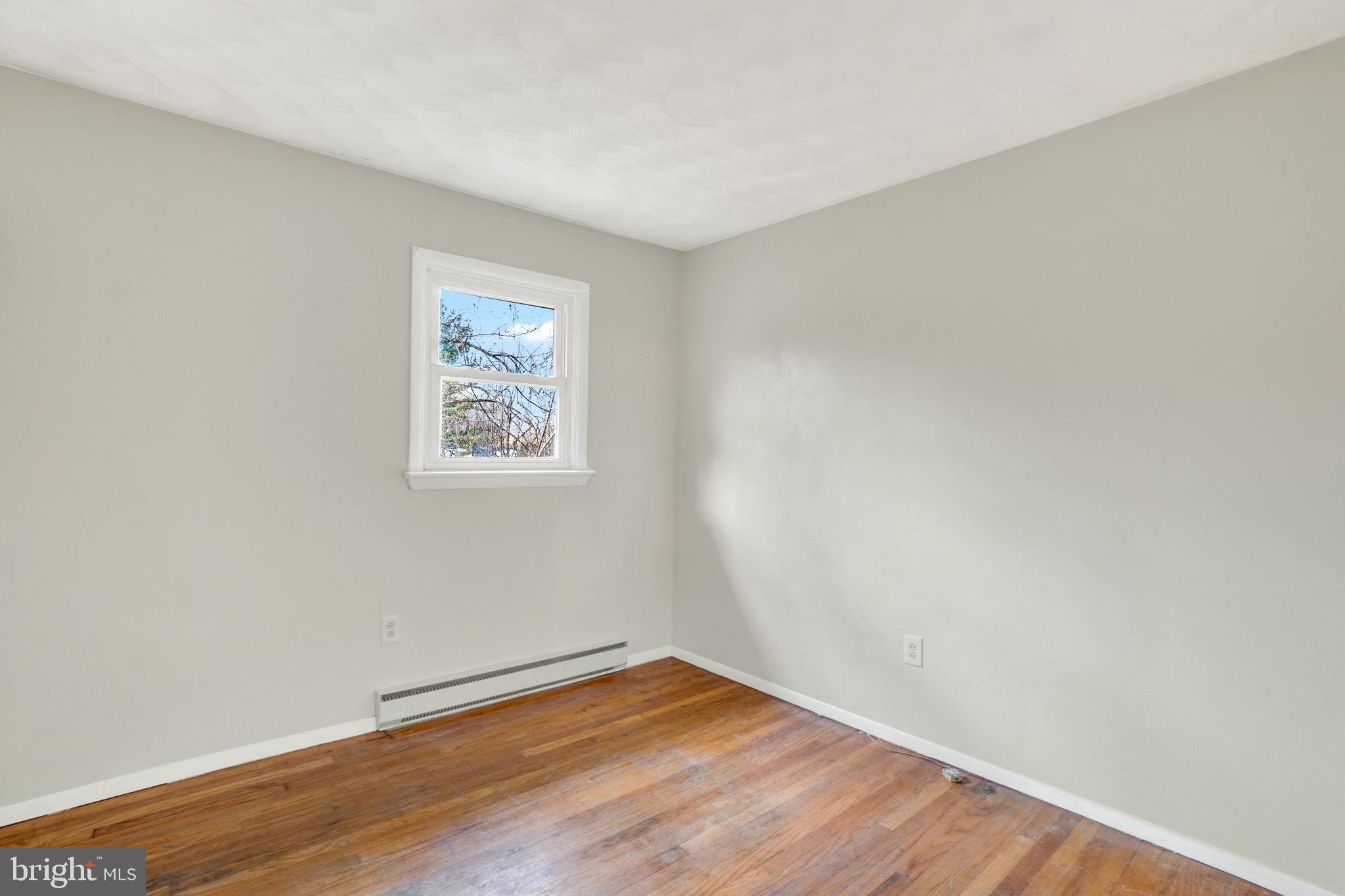 5714 Spruce Road Felton, PA 17322 - Photo 16 of 33 an empty room with wooden floor and windows
