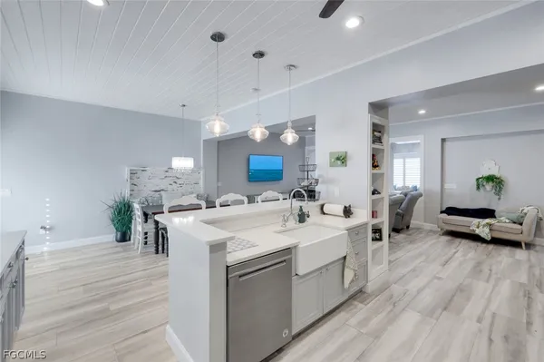 a view of living room kitchen island with furniture and wooden floor