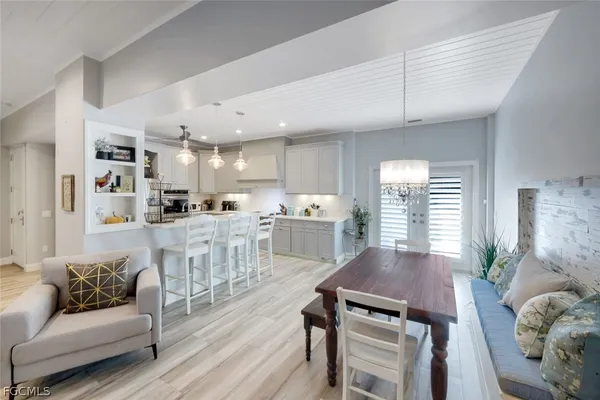 a living room with kitchen island furniture and a kitchen view