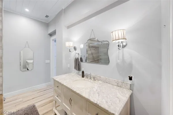 a bathroom with a granite countertop sink and a mirror