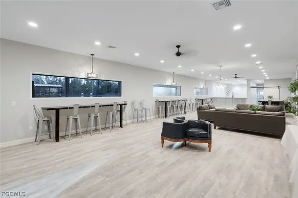a living room with stainless steel appliances kitchen island granite countertop furniture and a kitchen view