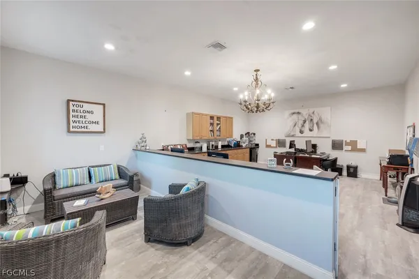 a living room with furniture and a chandelier