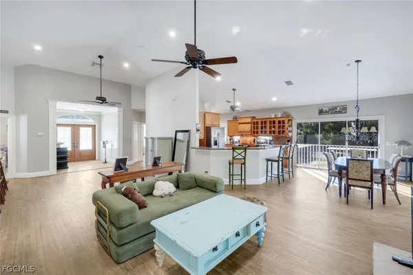 a living room with furniture kitchen and a wooden floor