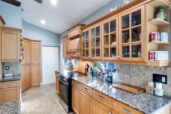 a kitchen with stainless steel appliances granite countertop a refrigerator and a sink