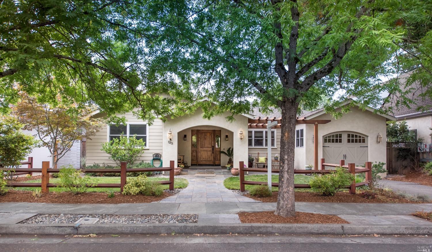 a front view of a house with a garden