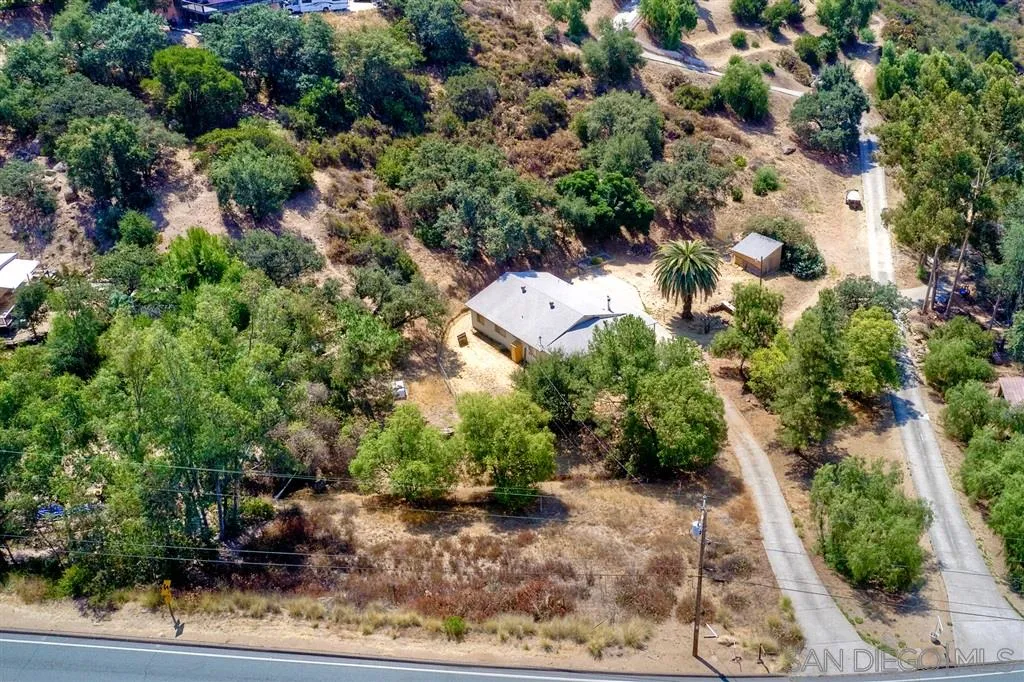 14941 Lyons Valley Road Jamul, CA 91935 - Photo 20 of 24 an aerial view of a house with a yard and large trees