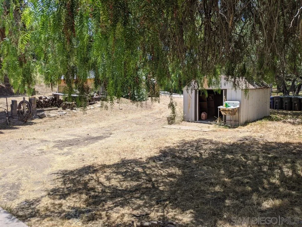 14941 Lyons Valley Road Jamul, CA 91935 - Photo 9 of 24 a view of a backyard with chairs and potted plants