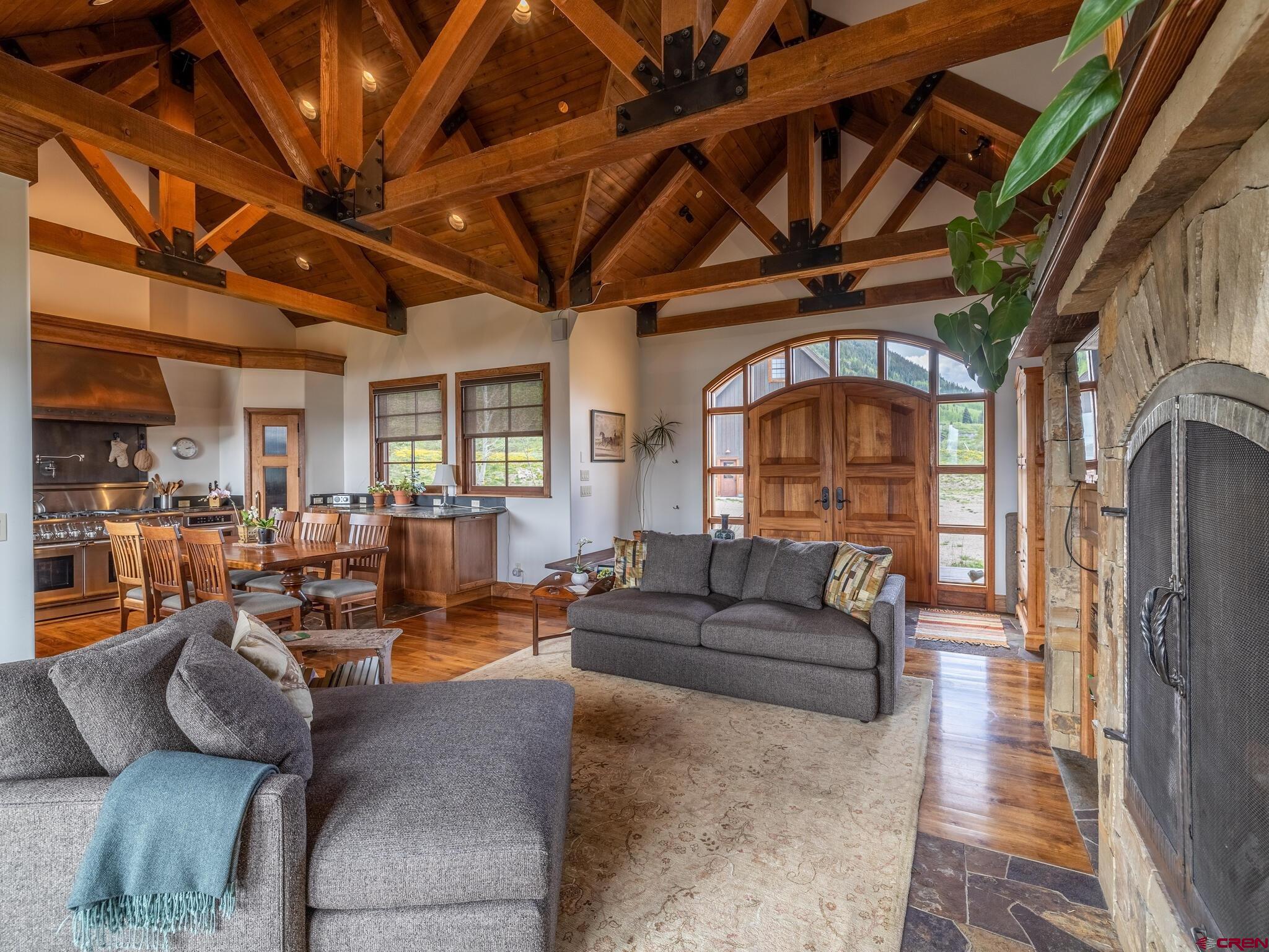 1482 Peanut Lake Road Crested Butte, CO 81224 - Photo 5 of 29 a living room with furniture a fireplace and a large window
