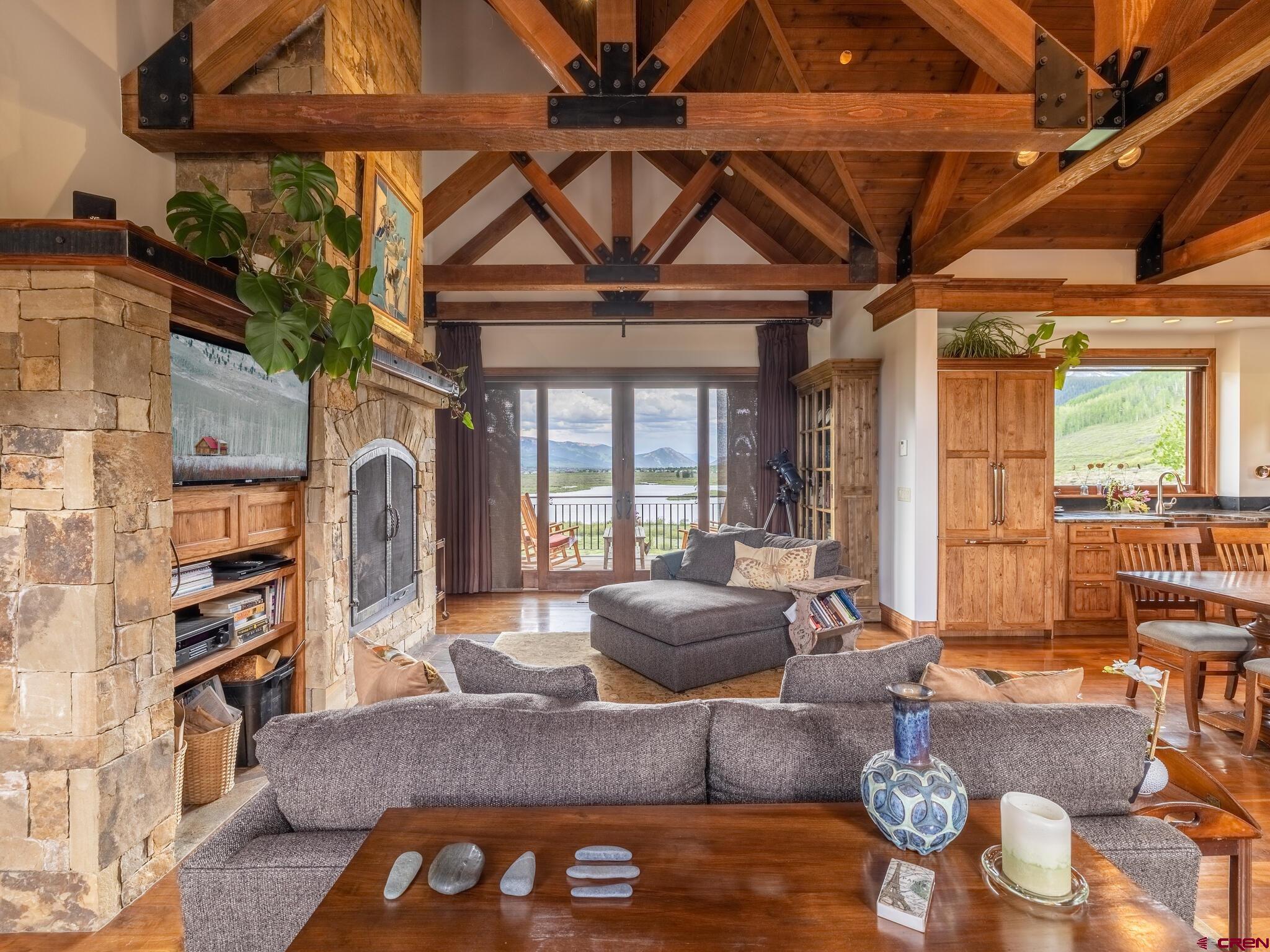 1482 Peanut Lake Road Crested Butte, CO 81224 - Photo 8 of 29 a living room with furniture a fireplace and a table