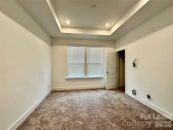 an empty room with a empty space and windows