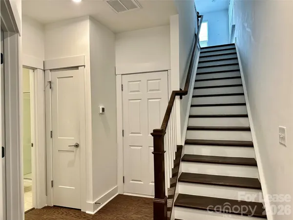 a view of an entryway with wooden floor