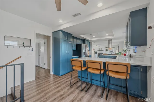 a bedroom with a bed window table chair and television