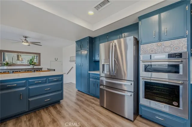 a spacious bathroom with double vanity and a mirror