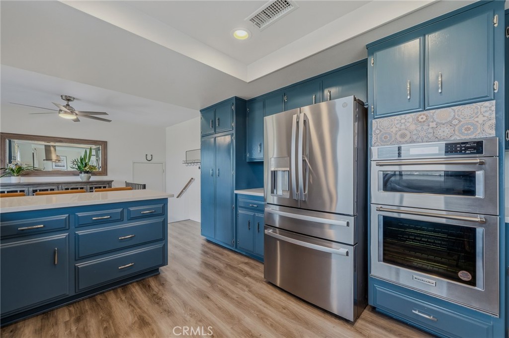 1864 Winterwarm Drive Fallbrook, CA 92028 - Photo 17 of 48 a kitchen with granite countertop stainless steel appliances and wooden floor