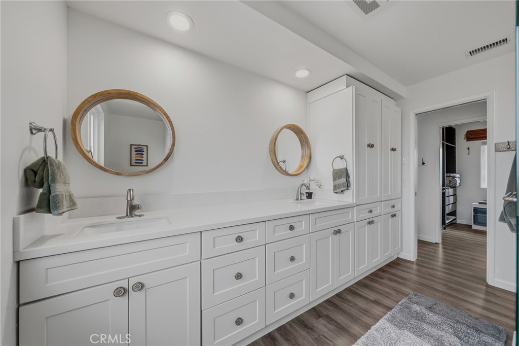 1864 Winterwarm Drive Fallbrook, CA 92028 - Photo 25 of 48 a spacious bathroom with double vanity and a mirror