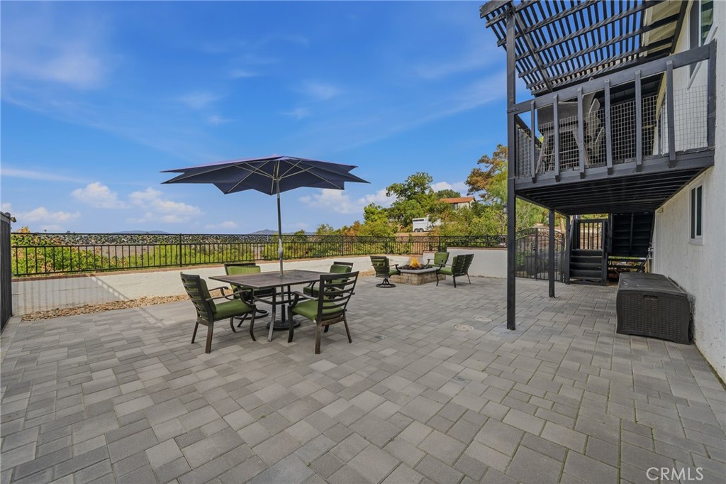 1864 Winterwarm Drive Fallbrook, CA 92028 - Photo 38 of 48 a view of a patio with a table and chairs under an umbrella