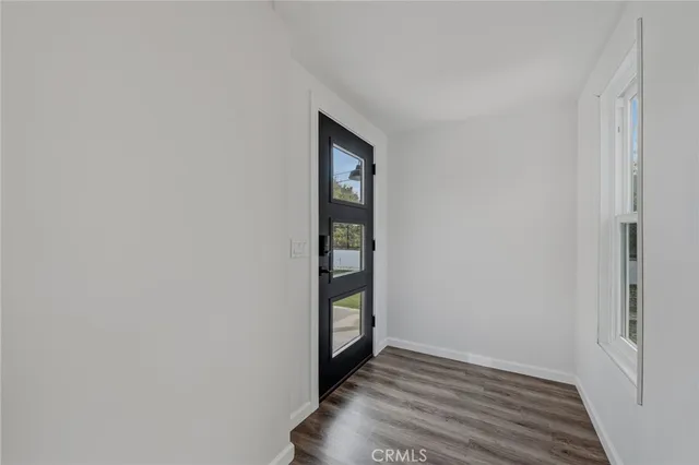 a kitchen with stainless steel appliances a sink stove and wooden floor