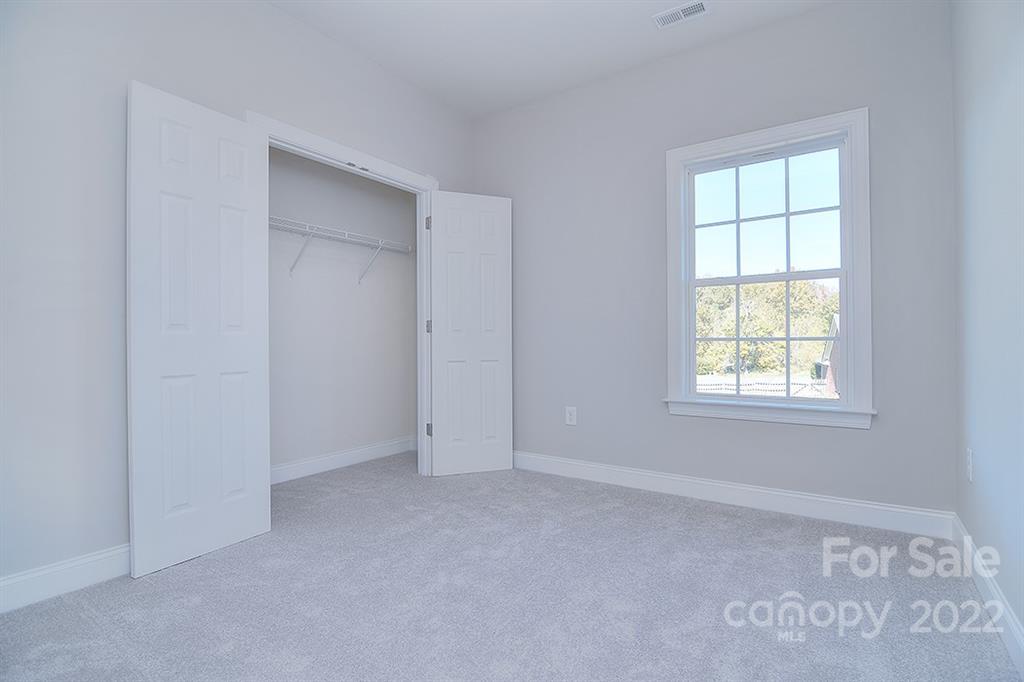 288 Ella Drive, Unit 101 Locust, NC 28097 - Photo 19 of 28 a view of an empty room with a window