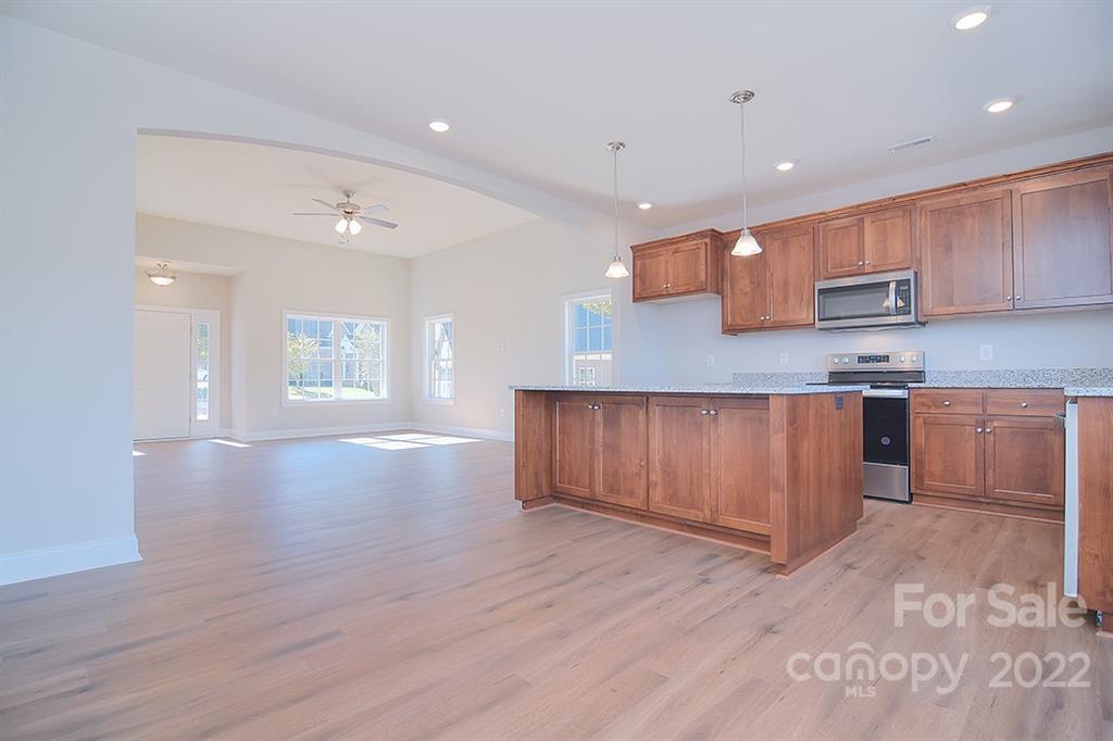 288 Ella Drive, Unit 101 Locust, NC 28097 - Photo 10 of 28 a kitchen with stainless steel appliances granite countertop a sink a stove a refrigerator and a oven