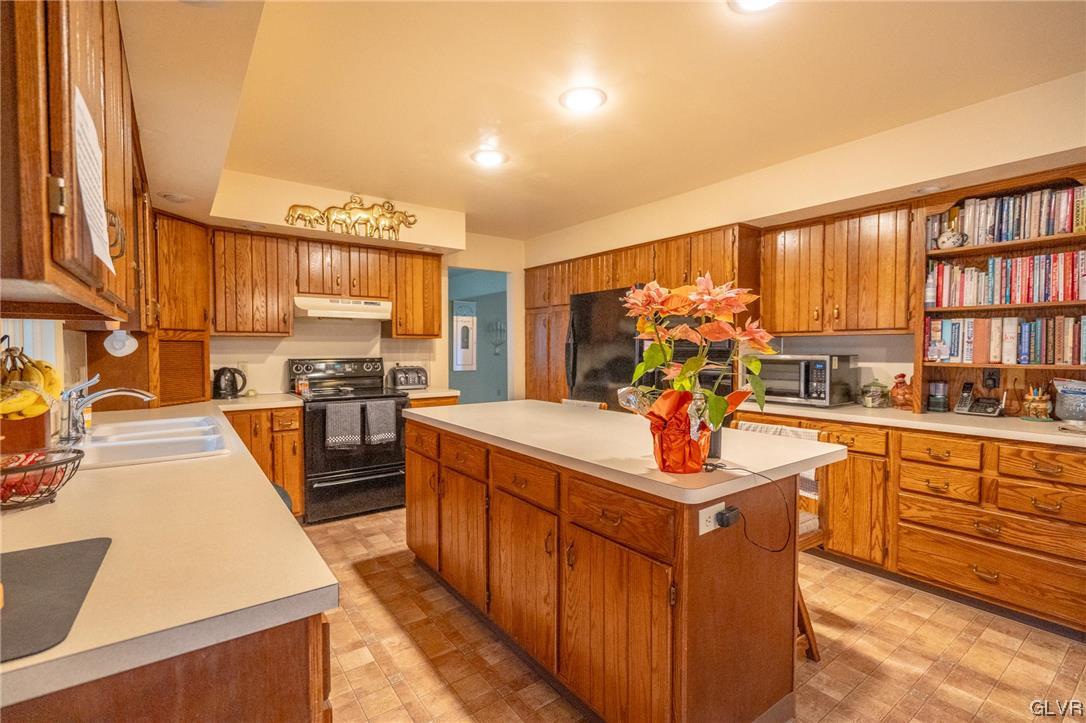 1540 Hidden Valley Road Allentown, PA 18103 - Photo 17 of 42 a kitchen with stainless steel appliances granite countertop a stove top oven a sink dishwasher and cabinets with wooden floor
