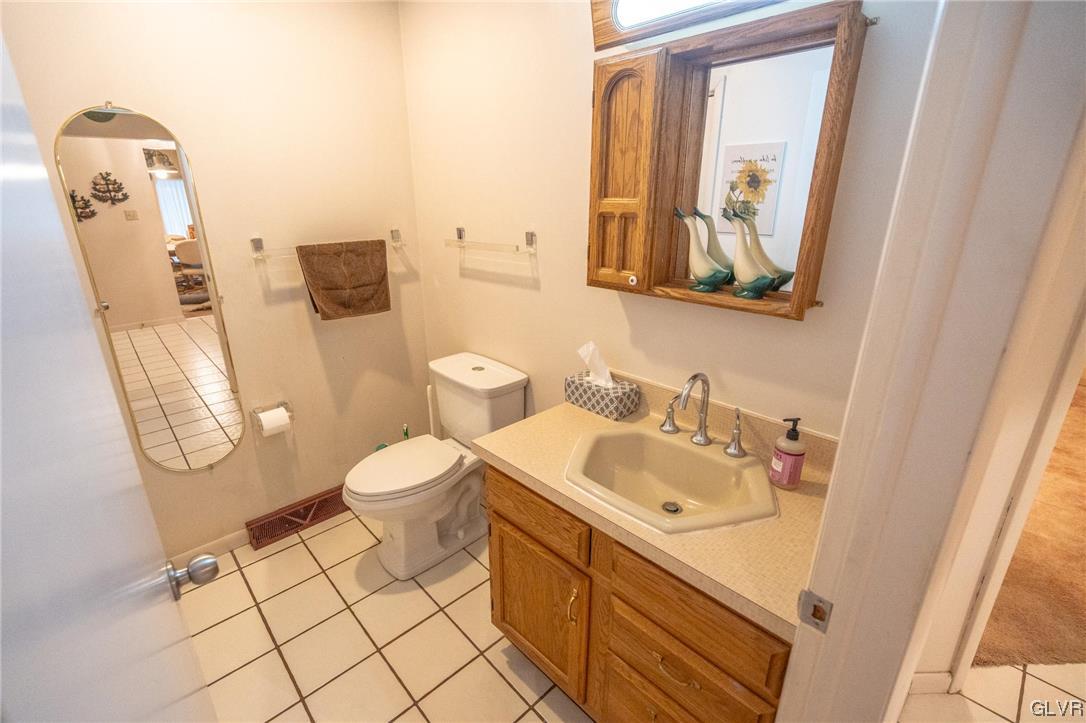 1540 Hidden Valley Road Allentown, PA 18103 - Photo 21 of 42 a bathroom with a toilet sink vanity and mirror