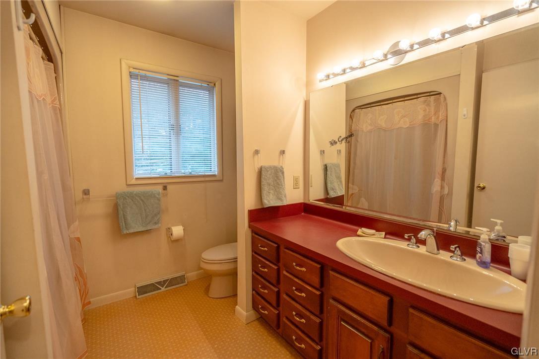 1540 Hidden Valley Road Allentown, PA 18103 - Photo 33 of 42 a bathroom with a granite countertop sink toilet and shower