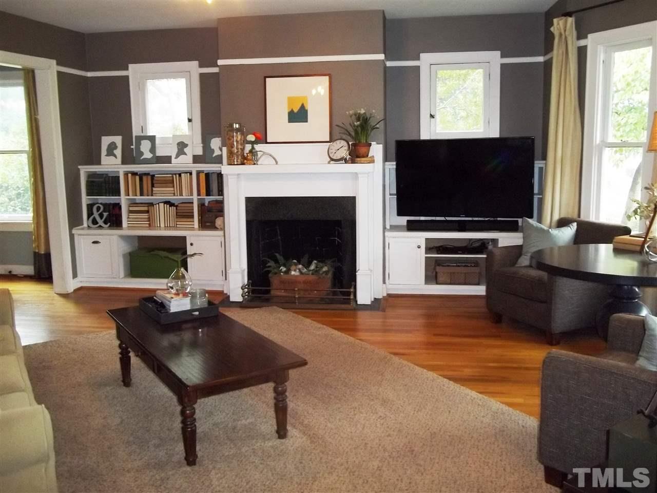 507 Cleveland Street Raleigh, NC 27605 - Photo 7 of 25 a living room with furniture a flat screen tv and a fireplace
