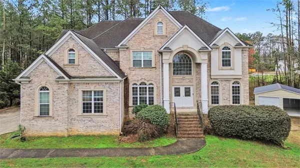 a front view of a house with a yard