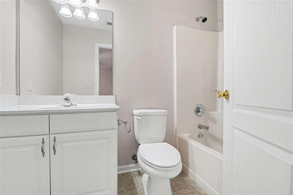 3183 Gus Robinson Road Powder Springs, GA 30127 - Photo 11 of 27 a bathroom with a sink a toilet and shower