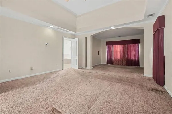 an empty room with windows and closet