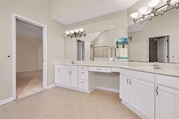 a bathroom with a sink vanity and a mirror