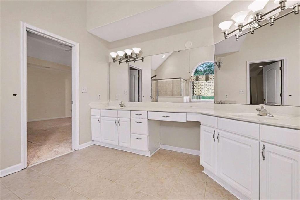 3183 Gus Robinson Road Powder Springs, GA 30127 - Photo 15 of 27 a bathroom with a sink vanity and a mirror