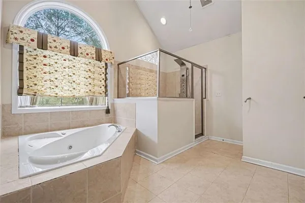 a bathroom with a bathtub and a shower