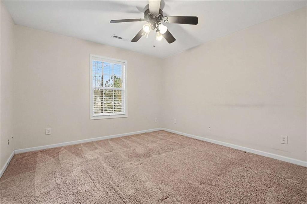3183 Gus Robinson Road Powder Springs, GA 30127 - Photo 18 of 27 an empty room with windows and fan