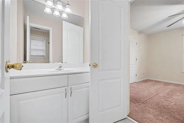 a bathroom with a sink vanity and a mirror