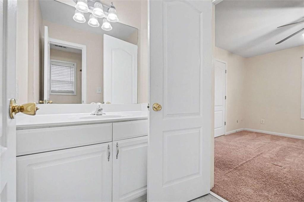 3183 Gus Robinson Road Powder Springs, GA 30127 - Photo 19 of 27 a bathroom with a sink vanity and a mirror