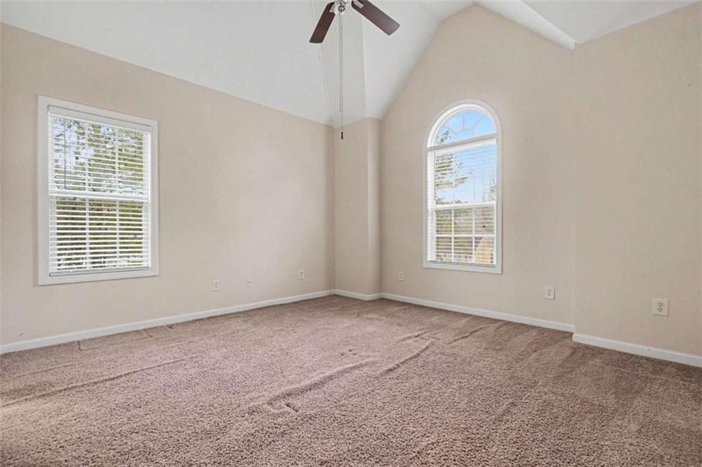 3183 Gus Robinson Road Powder Springs, GA 30127 - Photo 20 of 27 an empty room with windows and fan