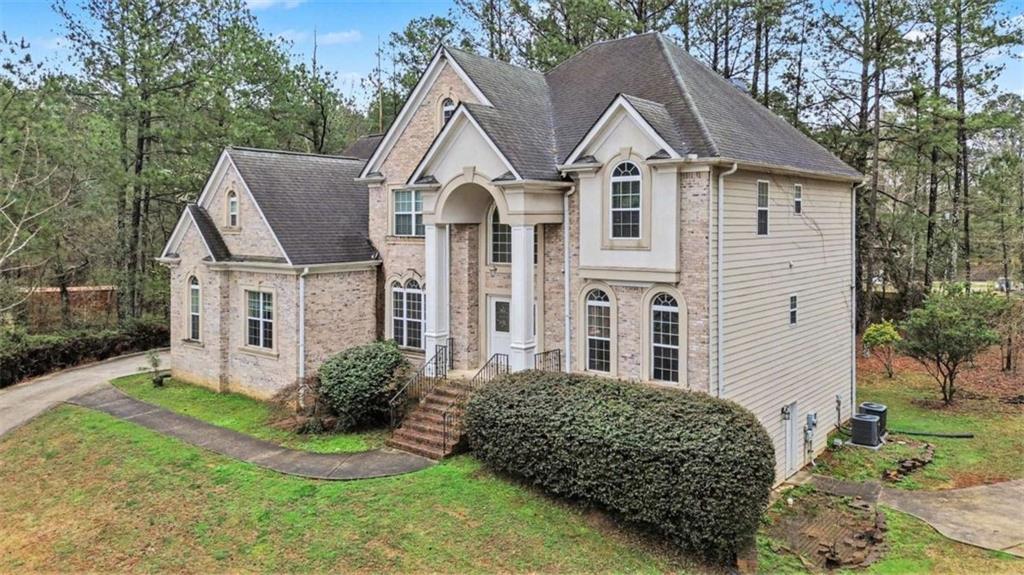 3183 Gus Robinson Road Powder Springs, GA 30127 - Photo 2 of 27 a front view of a house with a yard