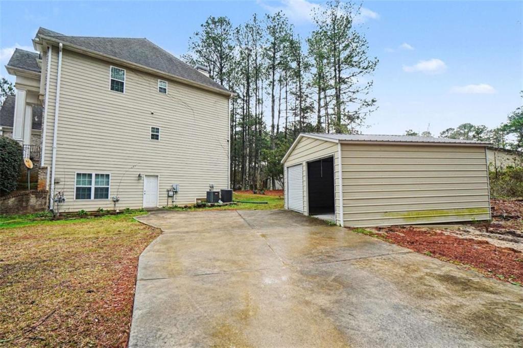 3183 Gus Robinson Road Powder Springs, GA 30127 - Photo 26 of 27 a view of a house with backyard and trees
