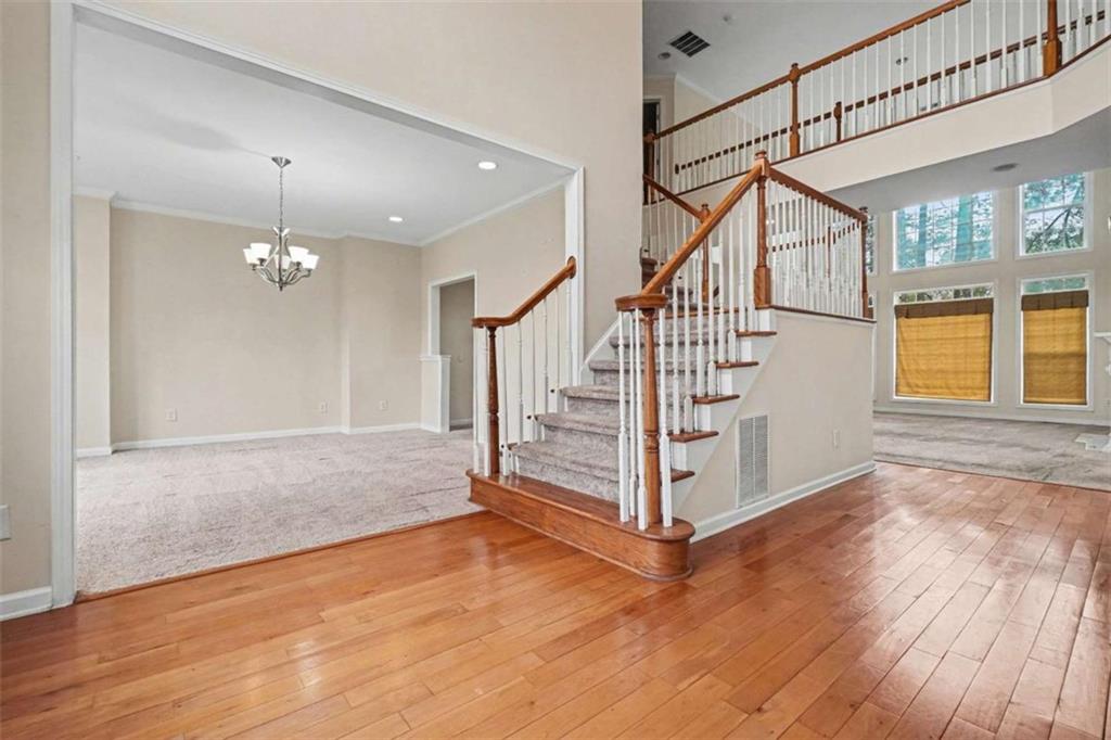 3183 Gus Robinson Road Powder Springs, GA 30127 - Photo 4 of 27 a view of an entryway with wooden floor windows and a chandelier