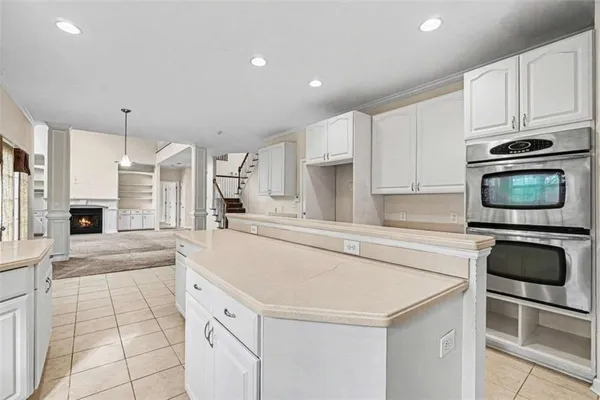a kitchen with granite countertop a sink and a stove top oven