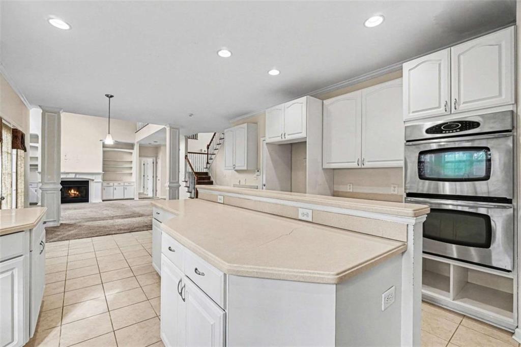 3183 Gus Robinson Road Powder Springs, GA 30127 - Photo 9 of 27 a kitchen with granite countertop a sink and a stove top oven