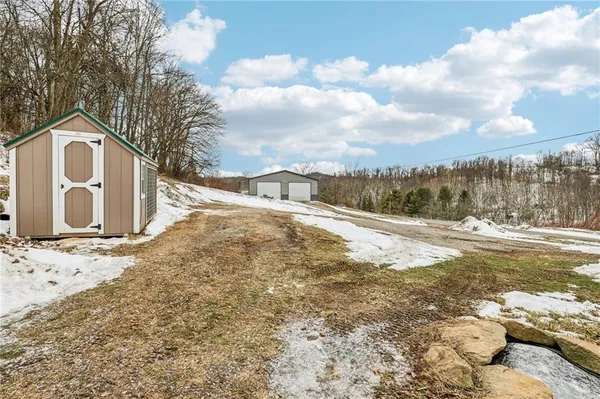 a view of a dry yard with a house