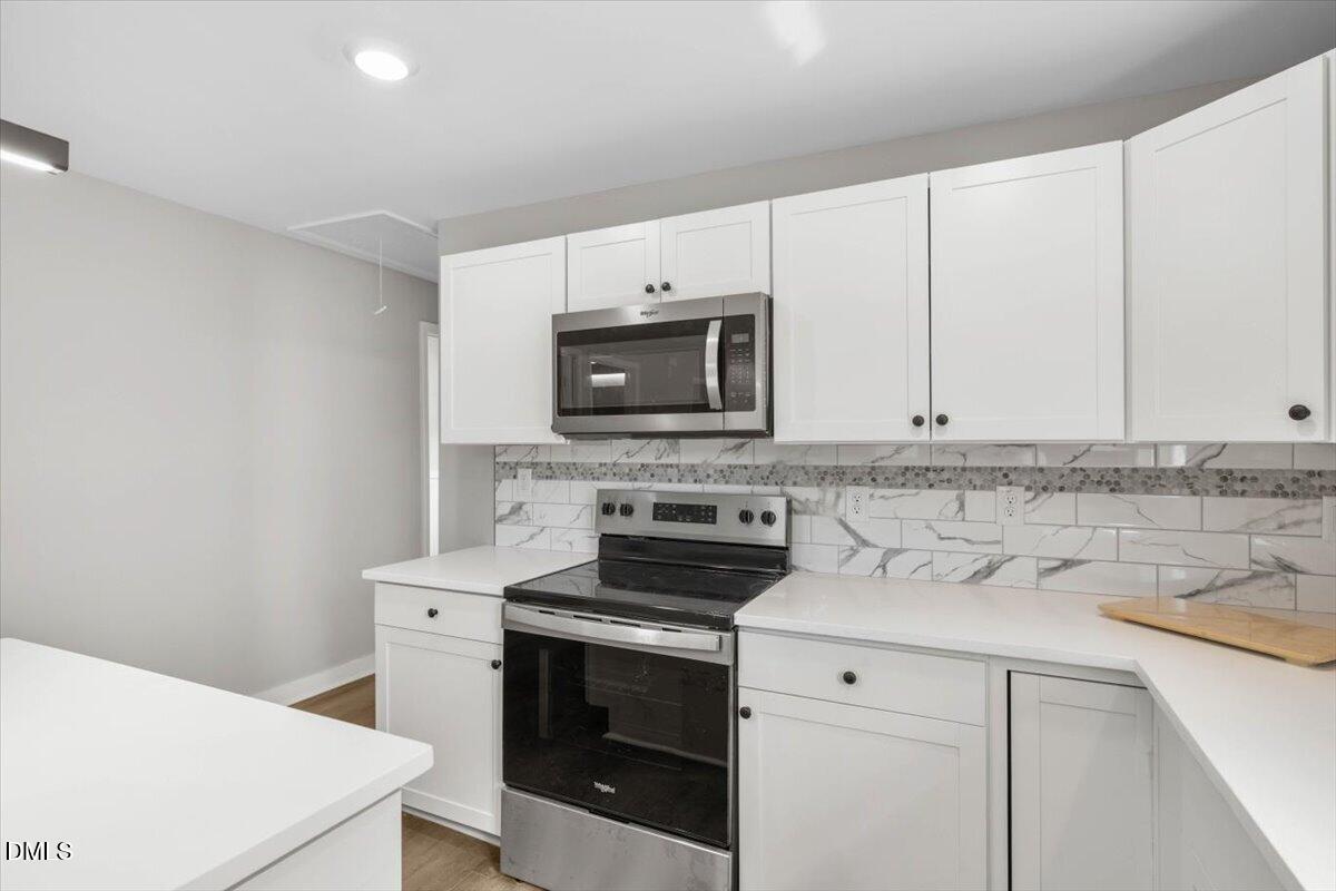 509 Sparella Street Durham, NC 27703 - Photo 12 of 30 a kitchen with a stove and a microwave
