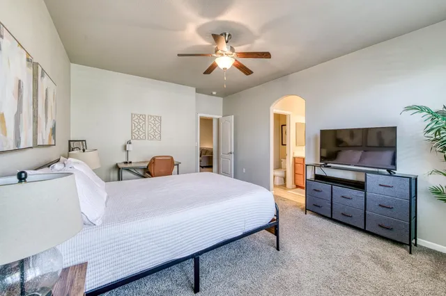 a bedroom with a bed and a flat screen tv