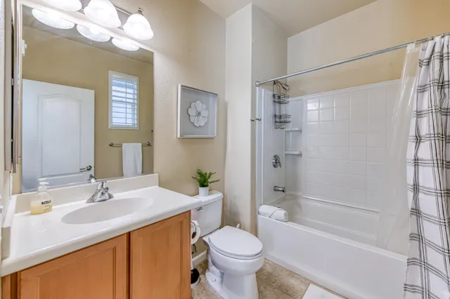 a bathroom with a sink toilet tub and shower
