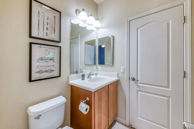 a bathroom with a toilet sink and mirror